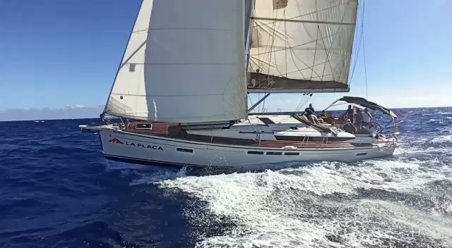 Sailboat heeled over with spray